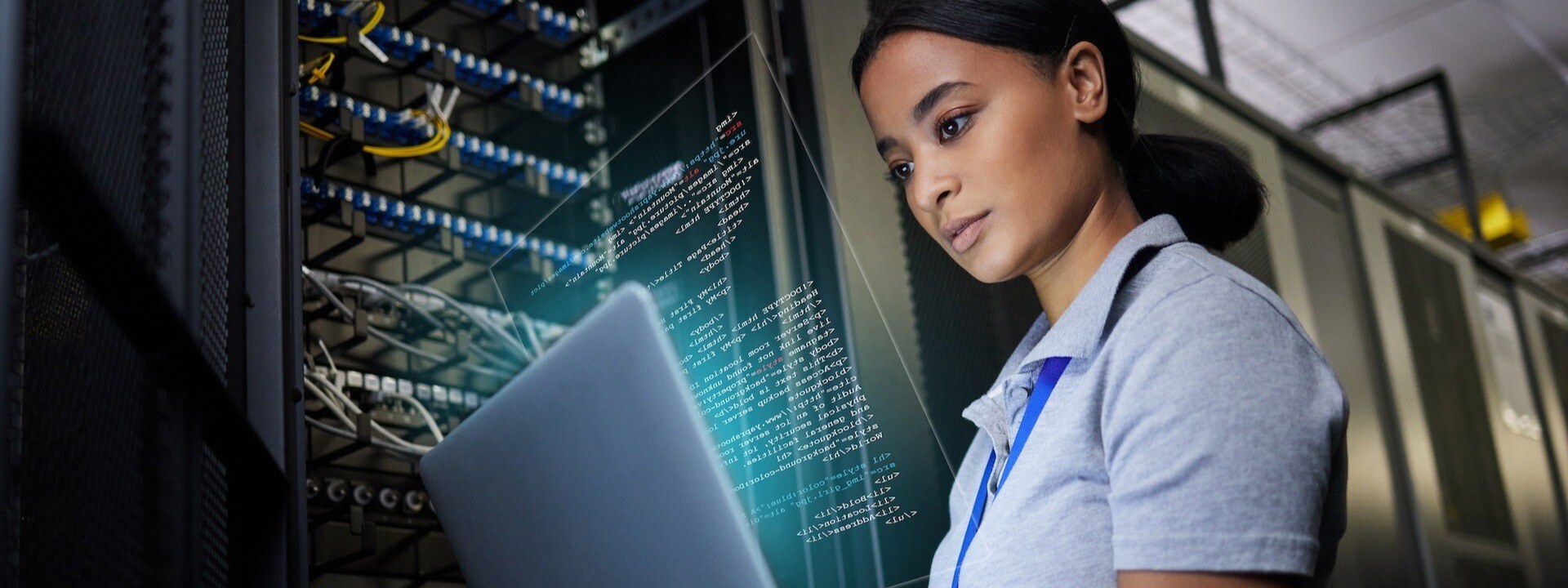 Laptop, network and data center with a black woman it support engineer working in a dark server room. 